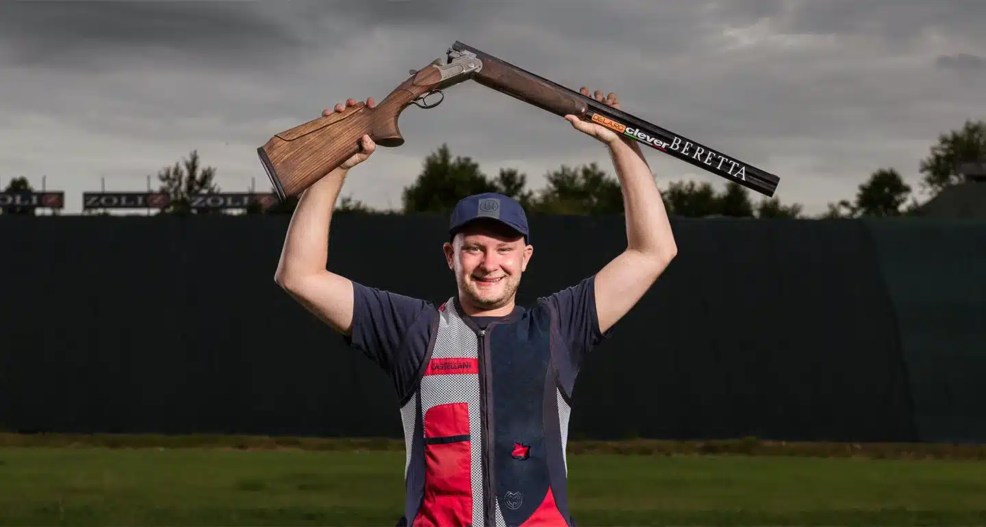 Nathan Hales holding up shotgun